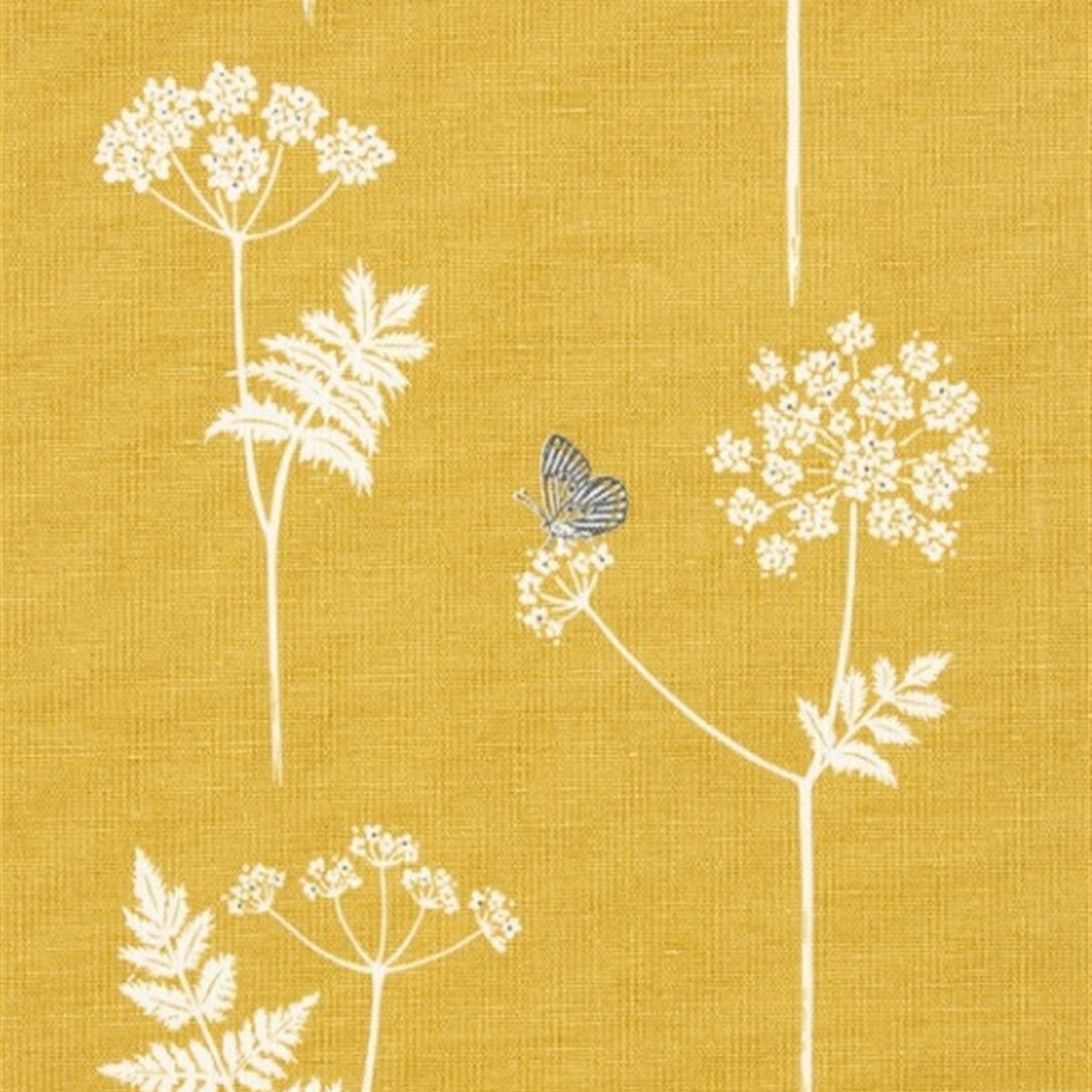 Detail of fabric in a playful flower and butterfly print in white and charcoal on a mustard field.