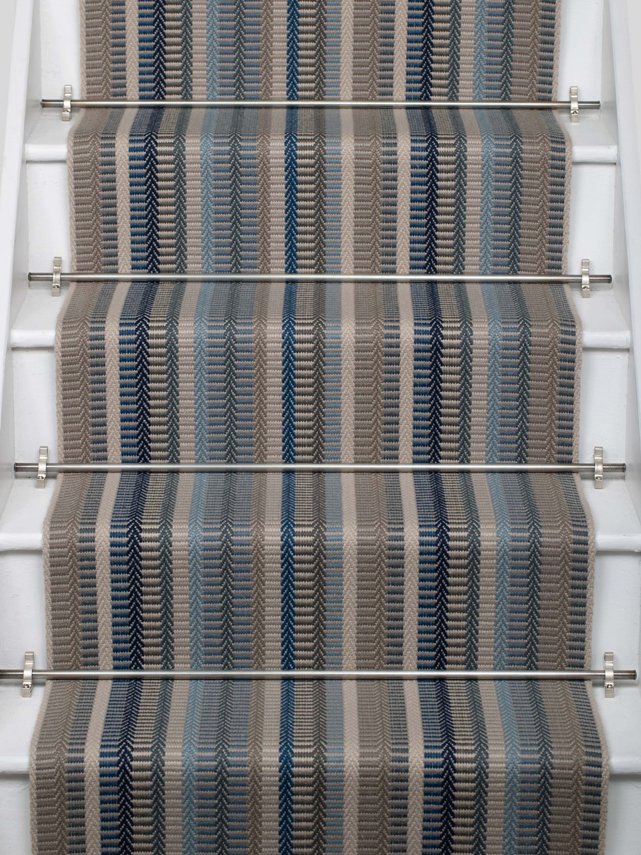 Striped flatweave runner in blue and grey on white staircase