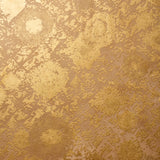 Detail of wallpaper in a textural botanical print in metallic gold on a brown field.