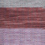 Close-up of a woven leather rug in a striped purple and pink colorway.