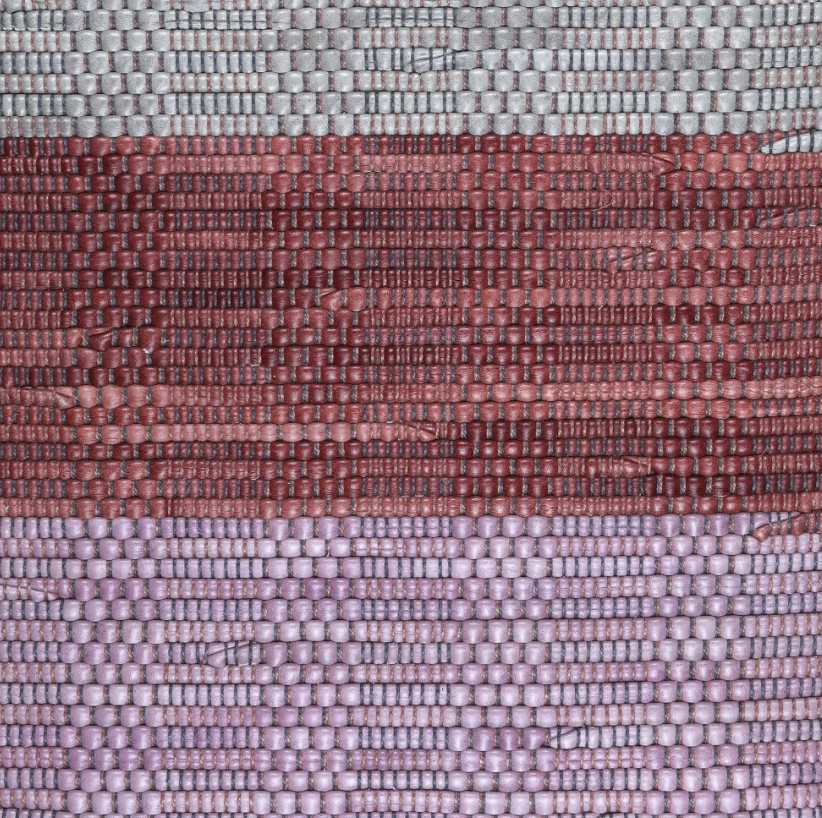 Close-up of a woven leather rug in a striped purple and pink colorway.