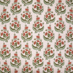 Patterned fabric with red flowers and green leaves on a beige background