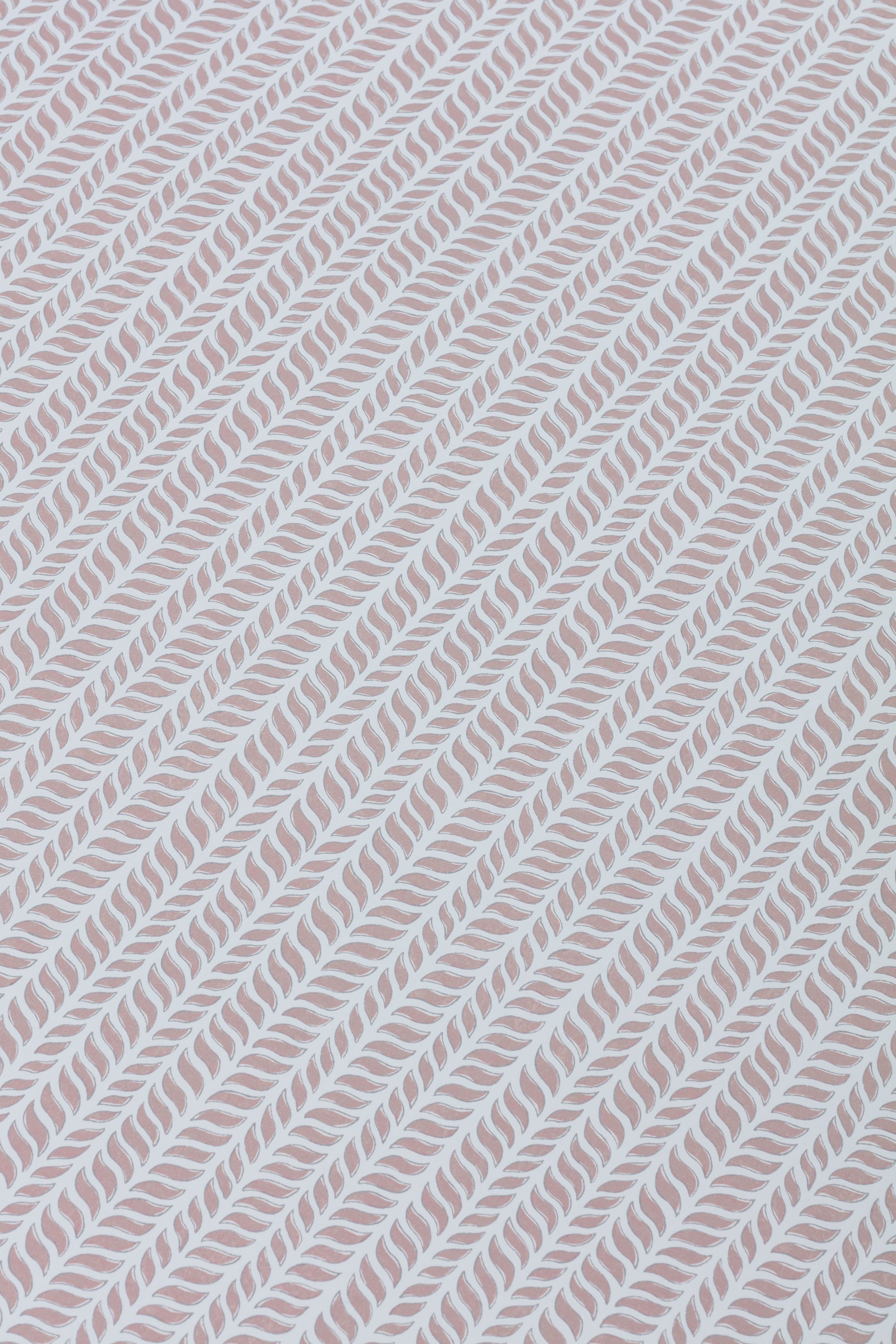 Detail of a wallpaper panel in a painterly herringbone print in mauve on a light blue field.