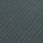 Detail of a wallpaper panel in a painterly herringbone print in green and light blue on a navy field.