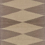 Geometric patterned rug with diamond shapes in brown and beige tones