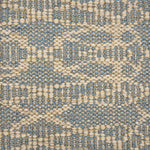 Handwoven rug detail in a geometric design in slate and beige