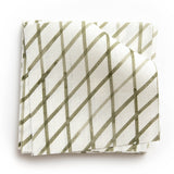 A stack of fabric swatches in an uneven grid pattern in sage on a white field.