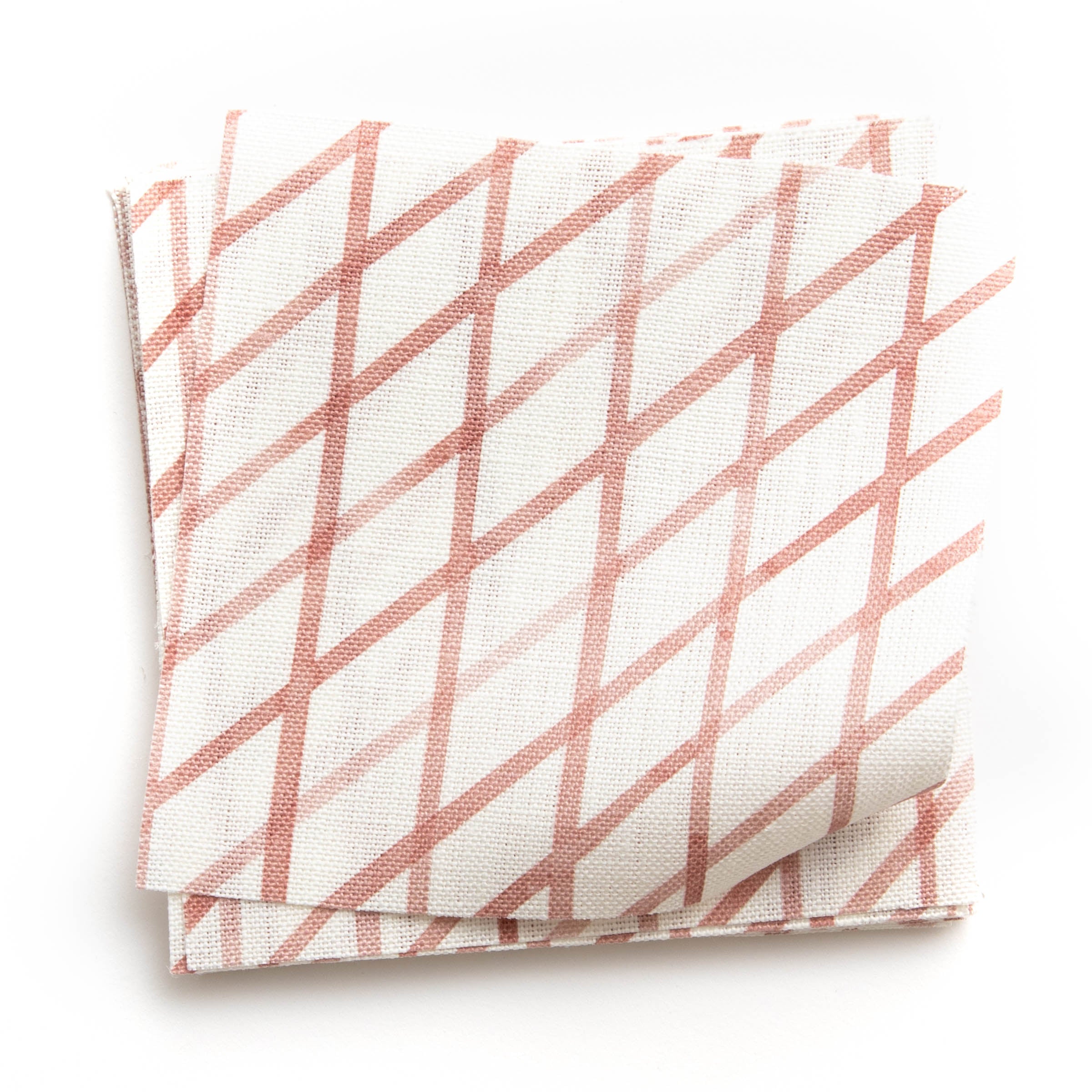 A stack of fabric swatches in an uneven grid pattern in rose on a white field.