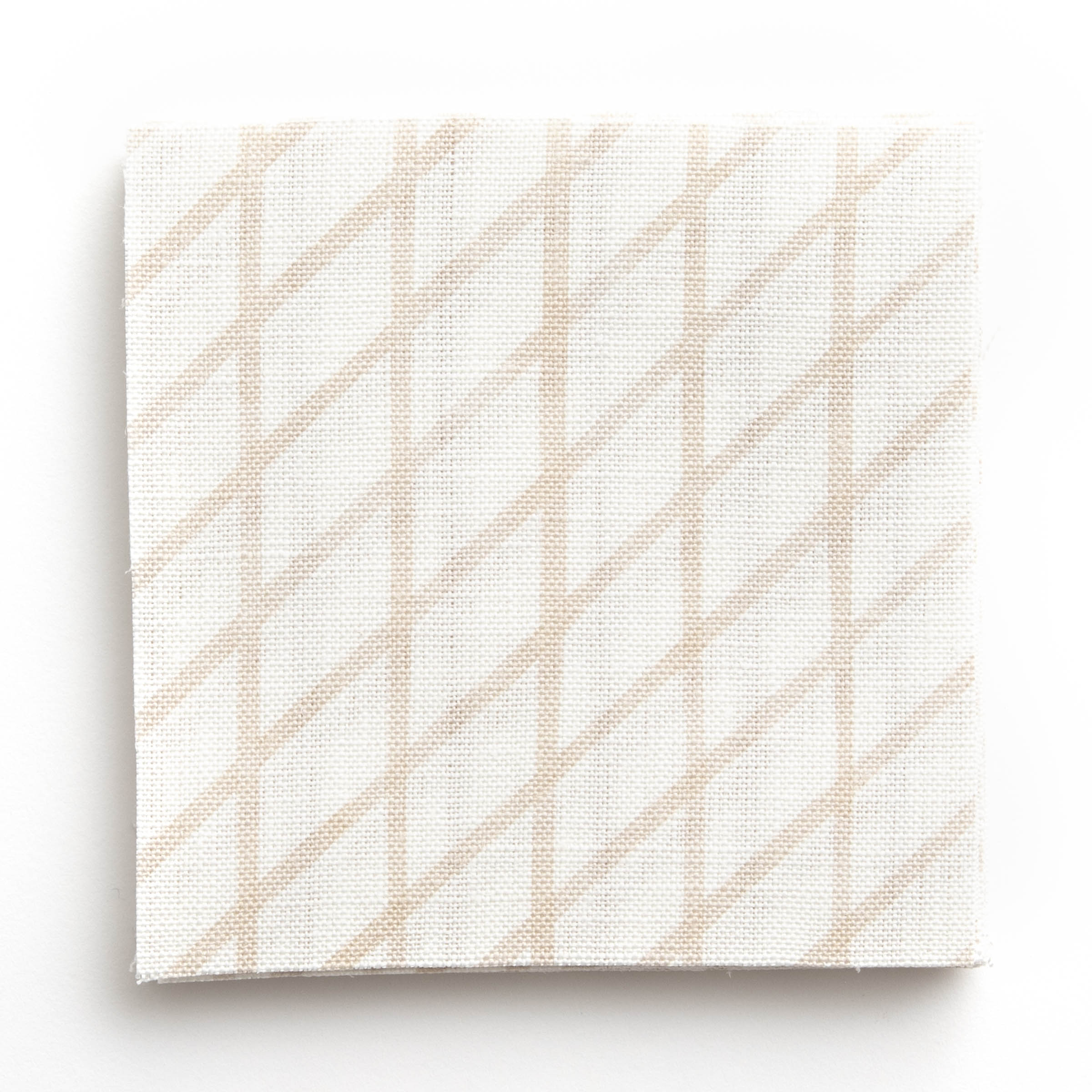 A stack of fabric swatches in an uneven grid pattern in cream on a white field.