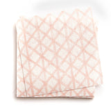 A stack of fabric swatches in an intricate striped grid pattern in light pink on a white field.