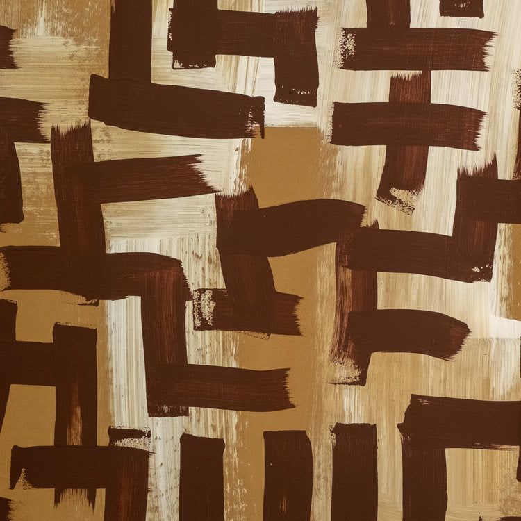 Detail of wallpaper in an abstract paint print in shades of brown, tan and cream.