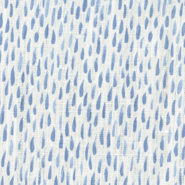 Fabric in a painterly dabbed print in blue on a white field.