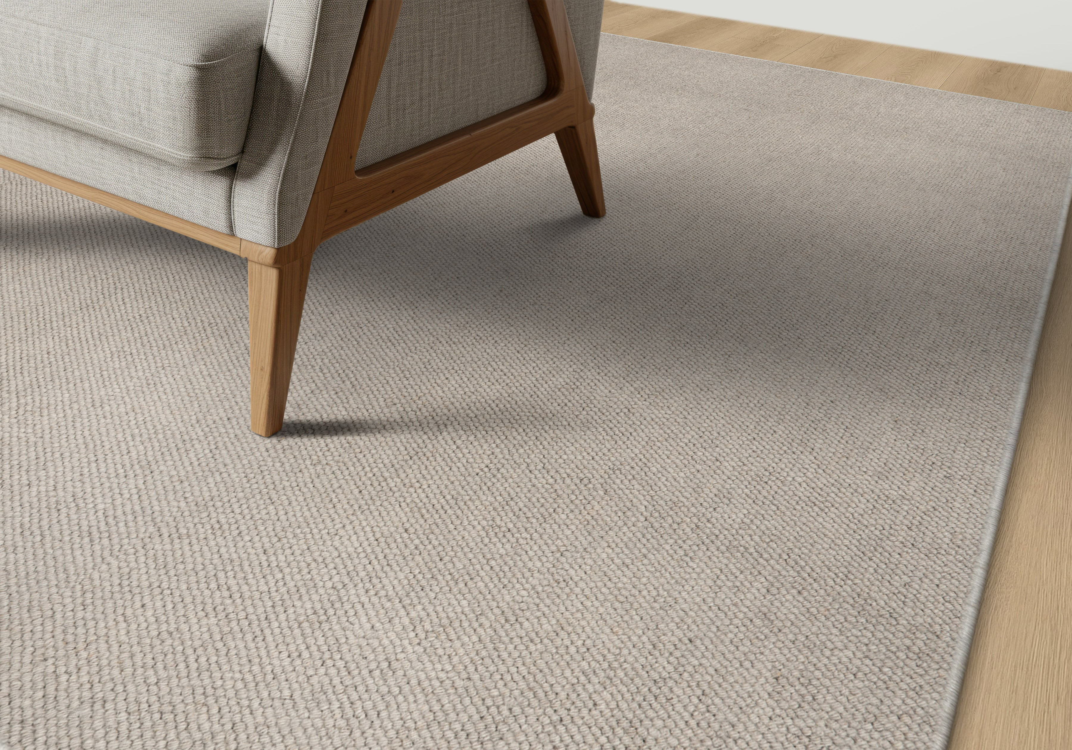 Beige carpet with a chair on a wooden floor