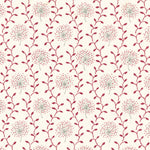 Detail of fabric in a repeating dandelion and leaf print in pink and red on a cream field.