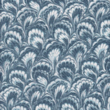 Detail of fabric in a marbled paint print in shades of blue, navy and white.