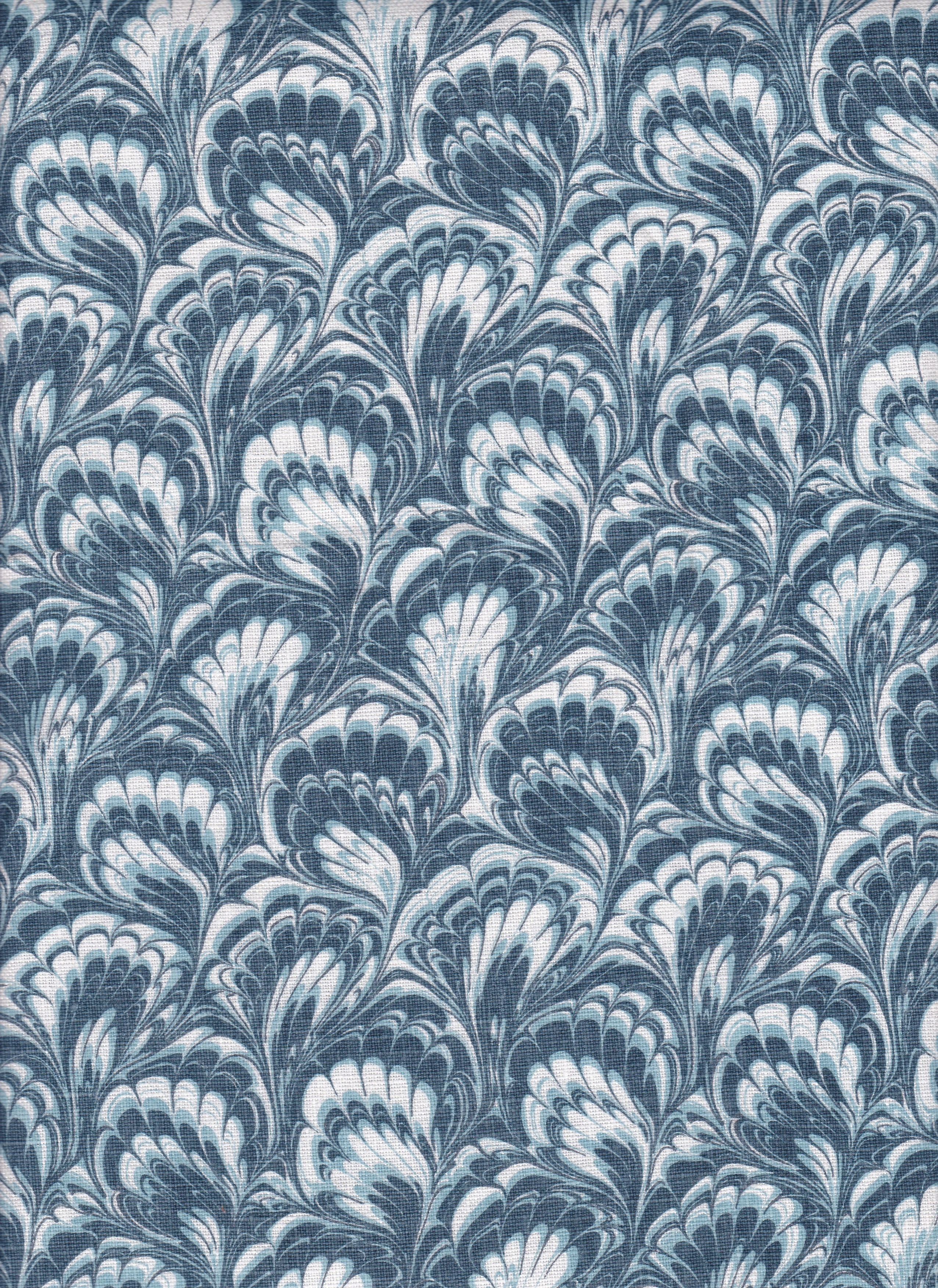 Detail of fabric in a marbled paint print in shades of blue, navy and white.