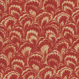 Detail of fabric in a marbled paint print in shades of red, orange and tan.