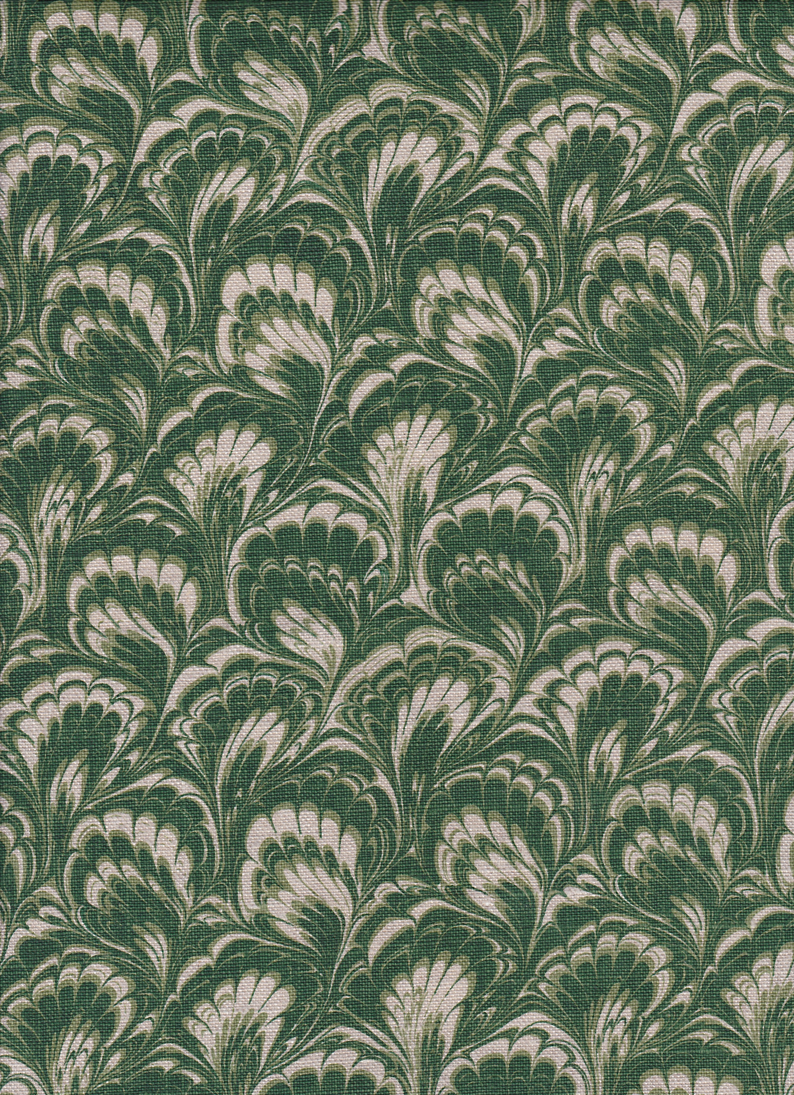 Detail of fabric in a marbled paint print in shades of green and cream.