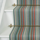 Striped flatweave runner in red green blue grey on white staircase