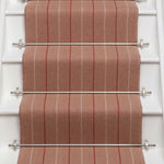 Striped flatweave runner in red and sand on white staircase