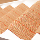 Striped flatweave runner in orange on white staircase