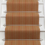 Striped flatweave runner in orange on white staircase