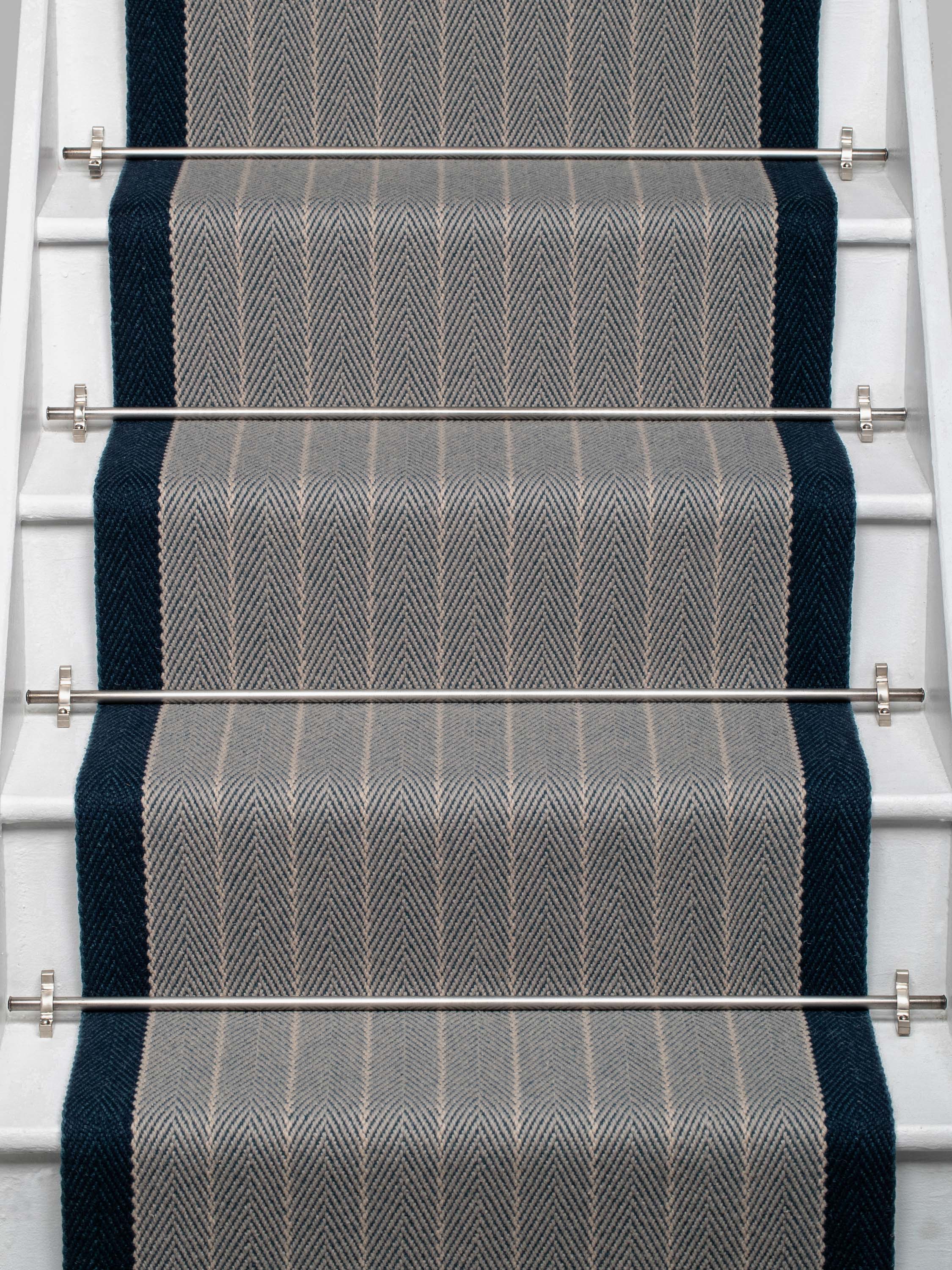 Striped flatweave runner in grey and dark blue on white staircase