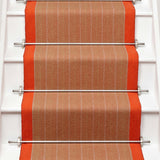 Striped flatweave runner in orange on white staircase