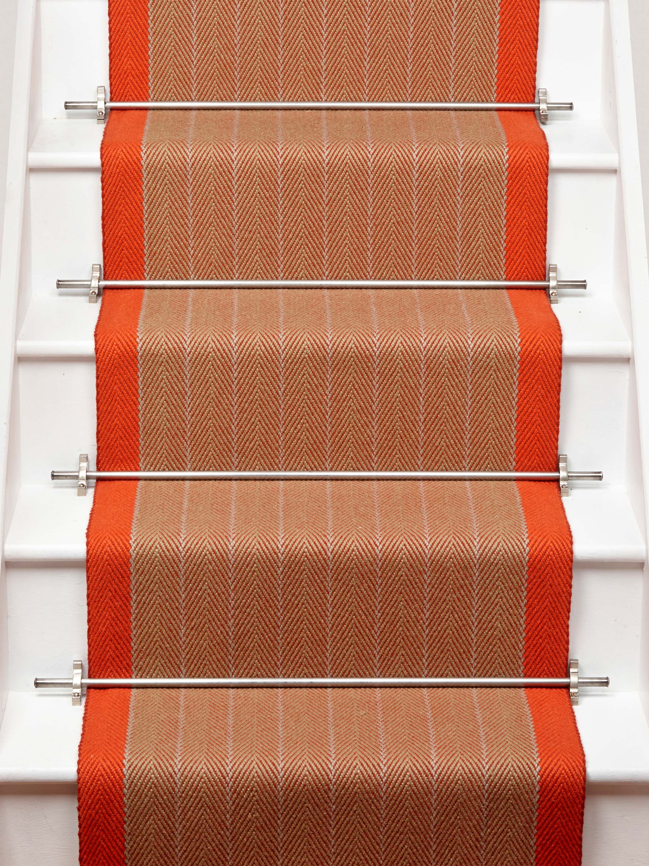 Striped flatweave runner in orange on white staircase