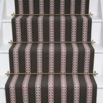 Striped flatweave runner in black and red and white on white staircase