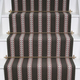 Striped flatweave runner in black and red and white on white staircase