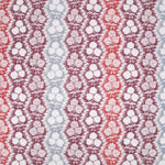 Fabric in a detailed botanical stripe print in shades of blue, red and purple on a white field.