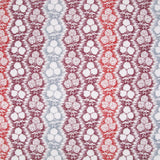 Fabric in a detailed botanical stripe print in shades of blue, red and purple on a white field.