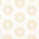 Detail of fabric in a repeating circular geometric print in yellow on a white field.