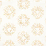 Detail of fabric in a repeating circular geometric print in yellow on a white field.