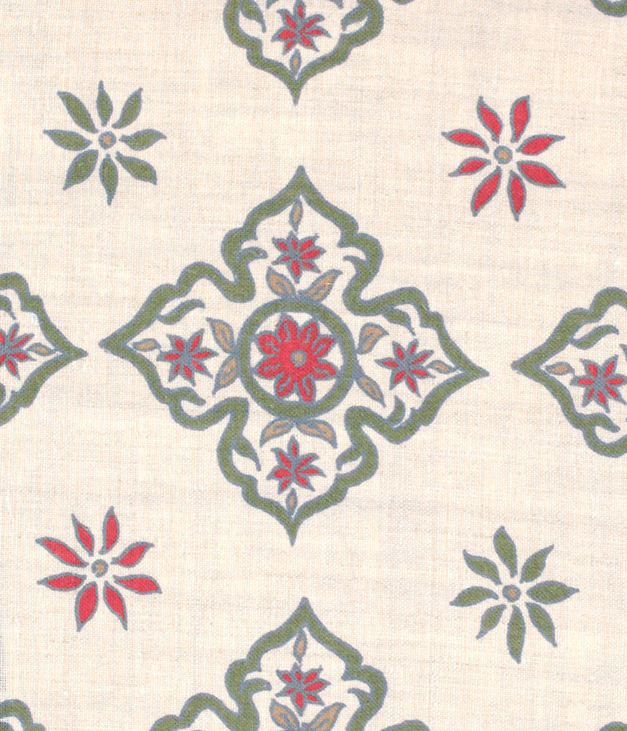 Detail of fabric in a diamond damask print in shades of green, red and blue on a tan field.