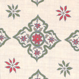 Detail of fabric in a diamond damask print in shades of green, red and blue on a tan field.