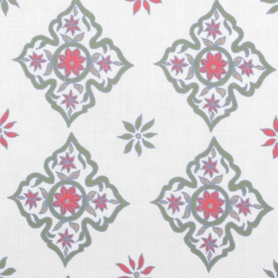 Detail of fabric in a diamond damask print in shades of green, red and blue on a cream field.