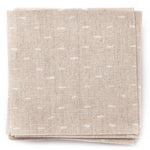 A stack of fabric swatches in a dotted diamond grid in white on a tan field.