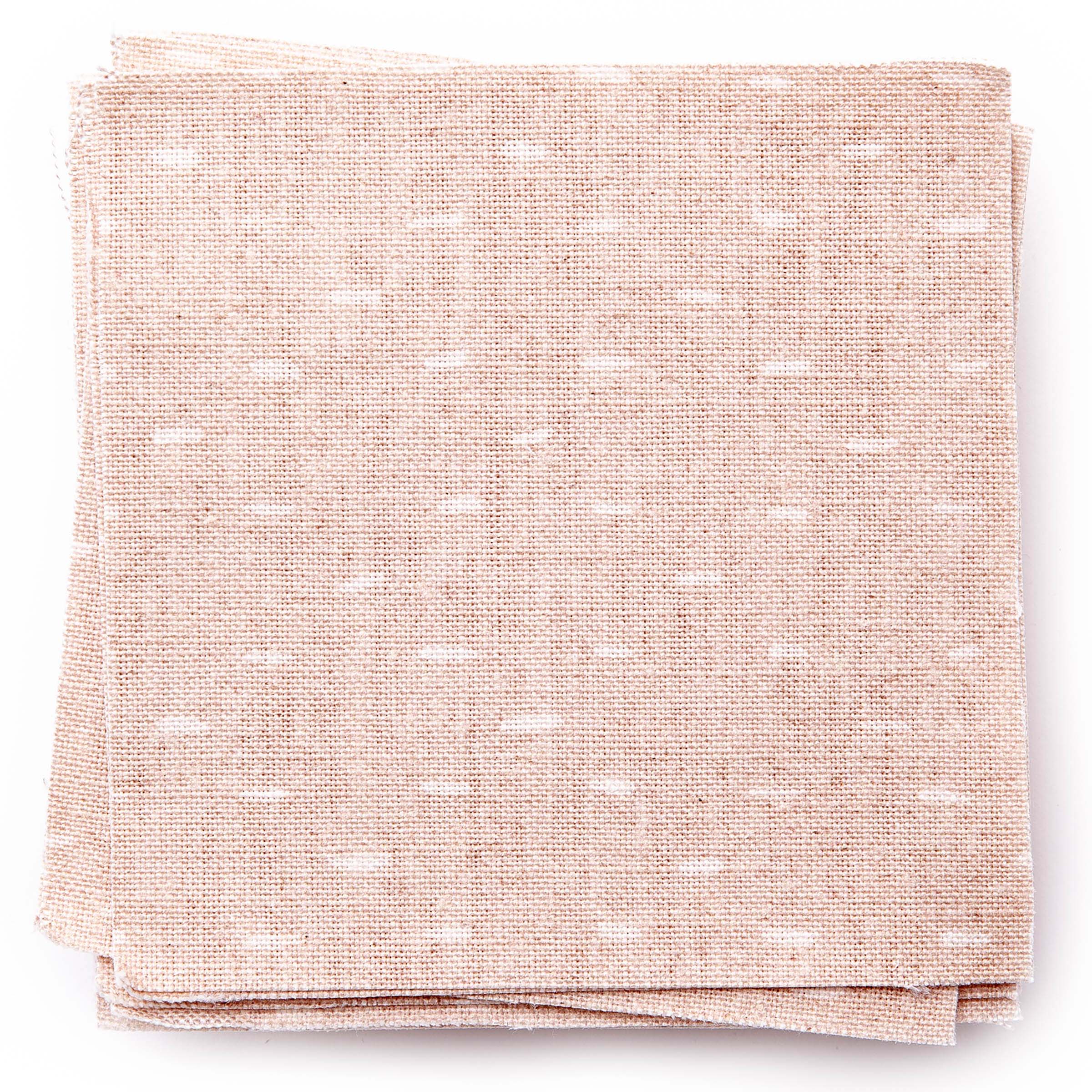 A stack of fabric swatches in a dotted diamond grid in white on a light pink field.