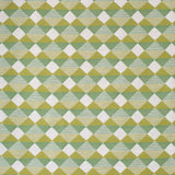 Detail of fabric in a textural diamond lattice print in cream on a green and mustard field.