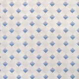 Detail of fabric in a textural diamond lattice print in blue on a cream field.