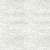 Detail of fabric in an abstract dotted pattern in light blue on a mottled cream field.