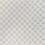 printed cotton fabric in a repeating dotted pattern in brown on a cream field.