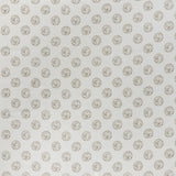 printed cotton fabric in a repeating dotted pattern in brown on a cream field.