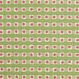 Detail of fabric in a playful dotted check print in pink and green on a cream field.