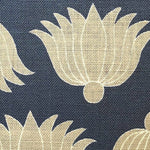 Detail of fabric in a repeating lotus print in yellow and white on a navy field.