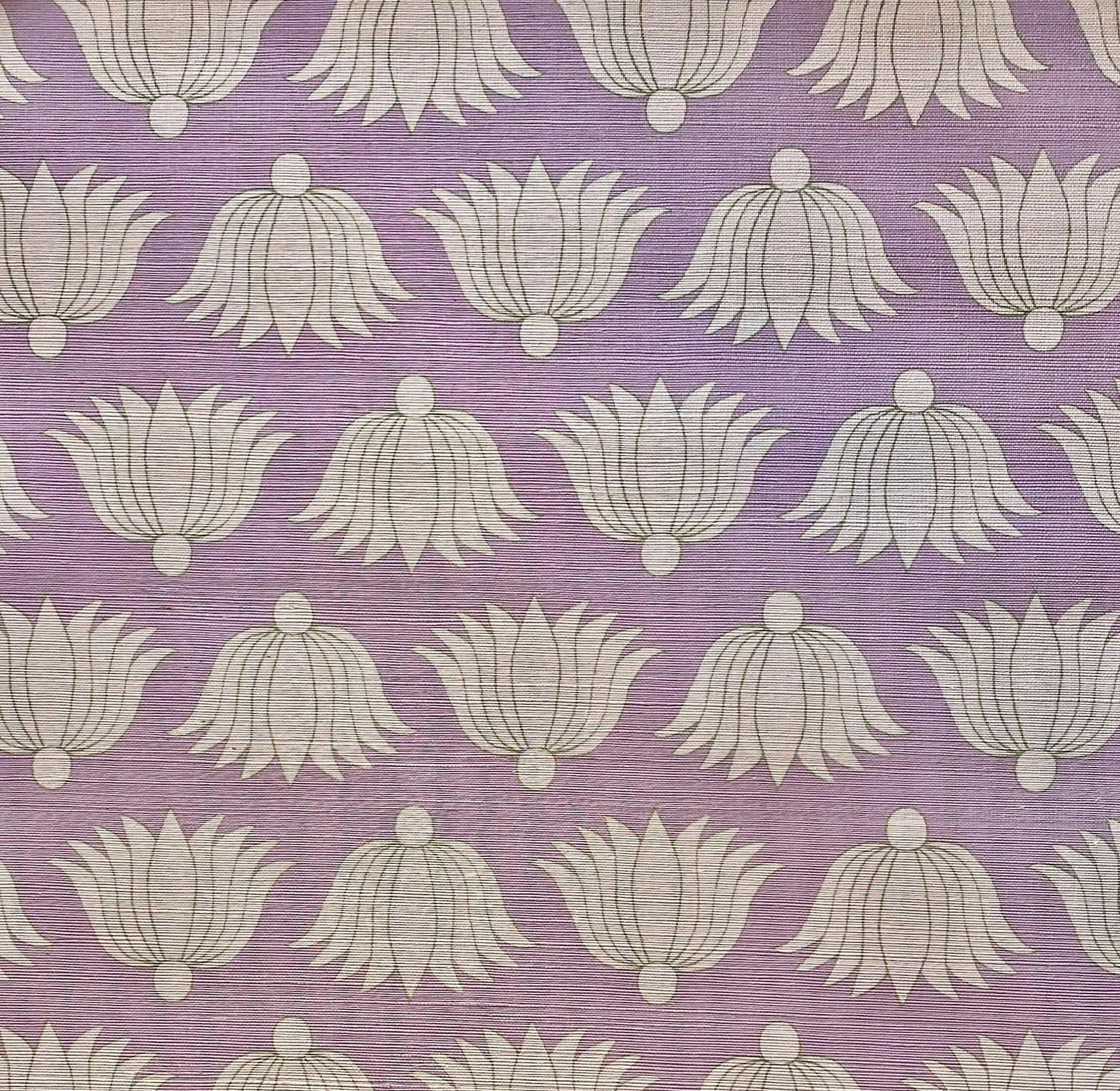 Detail of fabric in a repeating lotus print in cream and tan on a light purple field.