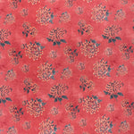 printed linen fabric in a repeating floral pattern in shades of yellow and green on a red field.