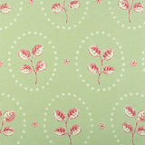 Detail of fabric in a repeating leaf print in red and cream on a light green field.